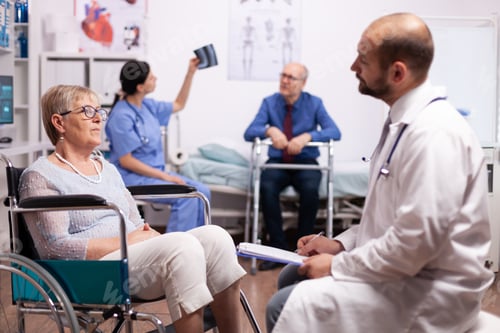 Preview: Elderly woman sitting in wheelchair in consultation room