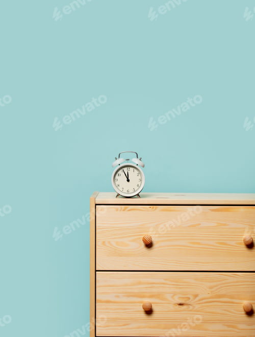Preview: vintage alarm clock on bedside table
