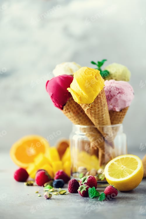 Preview: Colorful red, pink, yellow, green, white ice cream balls in waffle cones with different flavors -