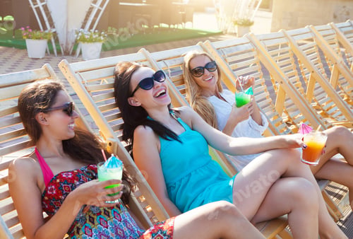 Preview: Girls with beverages on summer party near the pool