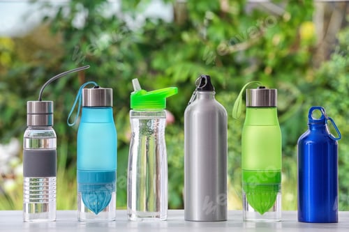 Preview: Sports water bottles on table against blurred background