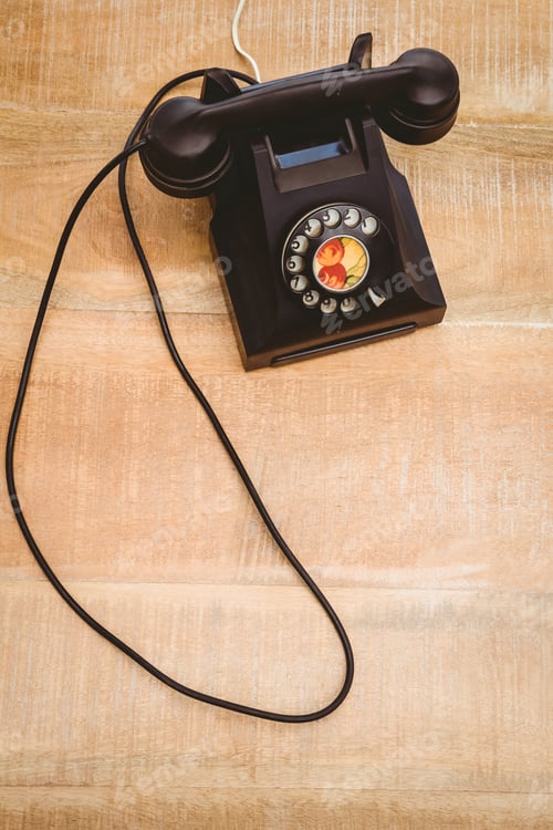 Preview: View of an old phone on wood desk