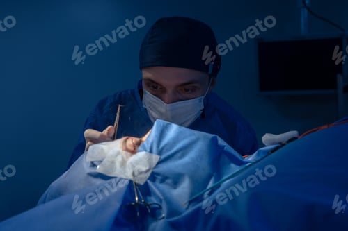 Preview: Surgeon Performing Delicate Surgical Procedure in Operating Room