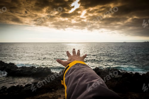 Preview: adventure concept for man hand like to touch the horizon. free travel spirit