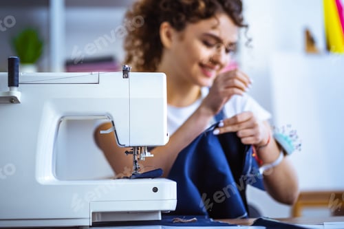 Preview: The happy tailor working near the sewing machine