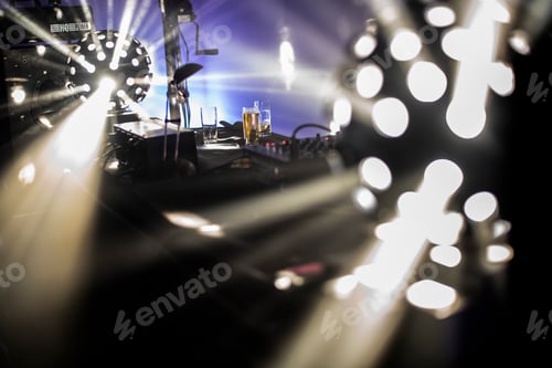 Preview: Concert stage with bright lights and musical equipment.