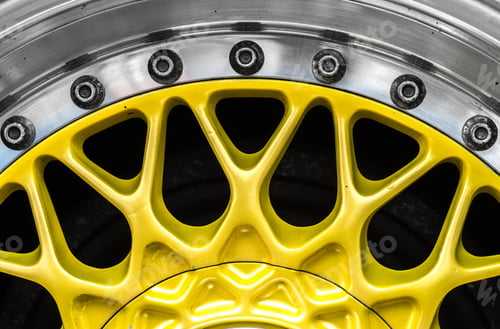 Preview: Closeup shot of the yellow metal hub of a car