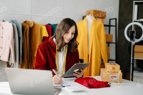 Preview: Fashion blogger concept, Young Asian women selling clothes on video streaming.