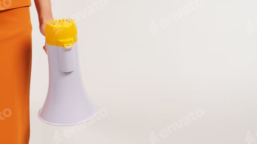 Preview: Hand is holding a megaphone and wearing a yellow suit on white background. The hand attachment body