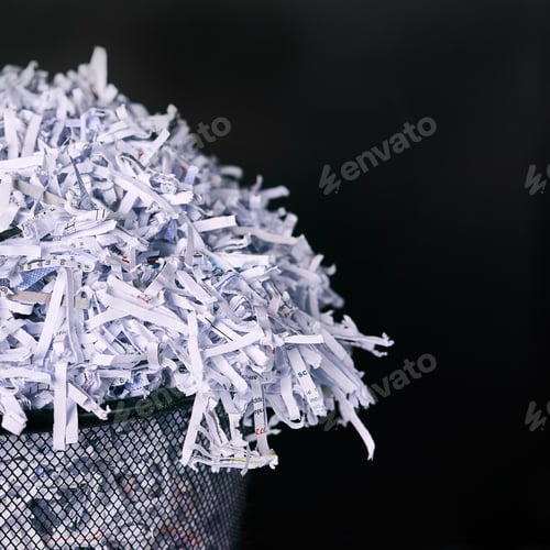 Preview: Leaving no paper trail. Studio shot of shredded paper in a dustbin against a black background.
