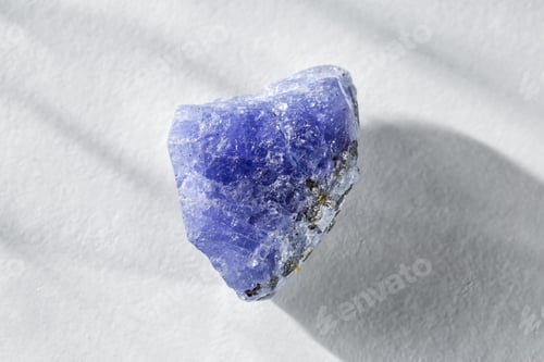 Preview: Rough Uncut Blue and Violet Tanzanite Gem on White