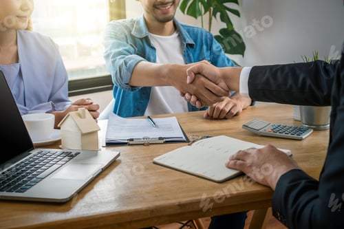 Preview: Closeup Hand shake between sale representative and house owner when sign contact