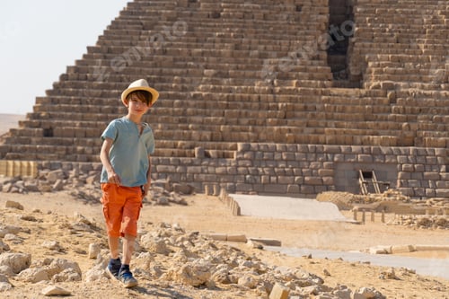 Preview: Boy walking in front of the pyramid of Mikerin on the Giza plateau