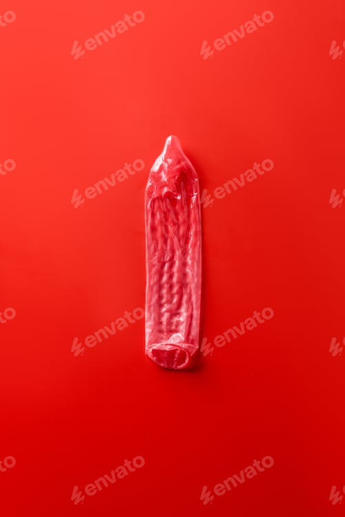 Preview: top view of red condom on red background