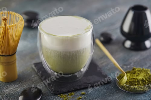 Preview: Matcha green tea on a blue-gray background. Match tea with a chapel and a bamboo spoon