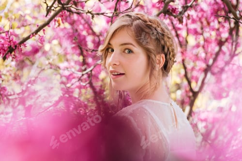 Preview: Happy woman walking in blooming garden