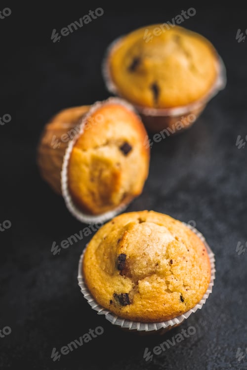 Preview: Sweet vanilla muffins on black table.