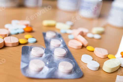 Preview: Scattered prescription drugs on brown table