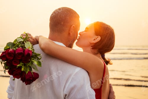 Preview: male making proposal with engagement ring to his girlfriend at sea beach.