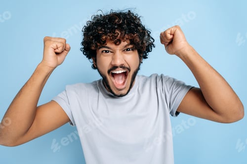 Preview: Enthusiastic amazed indian or arabic guy, rejoices in success, victory, win, gesturing with fists