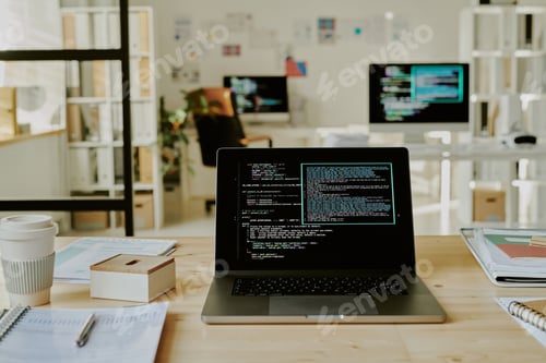 Preview: Laptop with Codes on Screen in Office