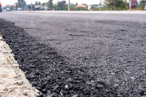 Preview: Machines are crushing the asphalt after pouring to make a road for cars.