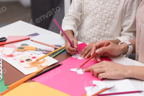Preview: cropped image of african american mother and daughter making paper hearts for greeting card