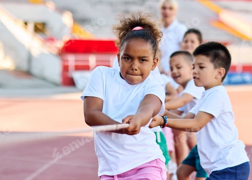 Preview: Children exercising during sport class outdoors on a stadium