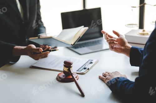 Preview: concept of justice and law A male judge in the courtroom on a wooden table and a male counselor or l