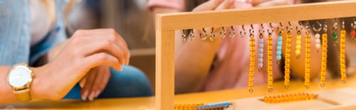 Preview: Cropped view of educational game by teacher and kid in montessori school, panoramic shot