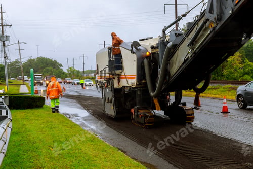 Preview: Road works asphalt removing machine loading powdered asphalt on the truck