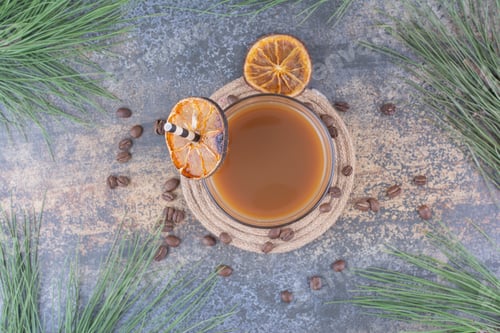 Preview: Glass of coffee with straw and orange slices