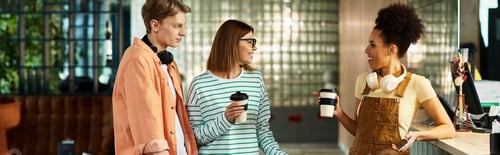 Preview: Colleagues enjoying a coffee break in a hotel while discussing business matters
