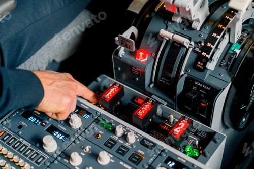 Preview: The captain presses the buttons on control panel to start the engine of the plane flight