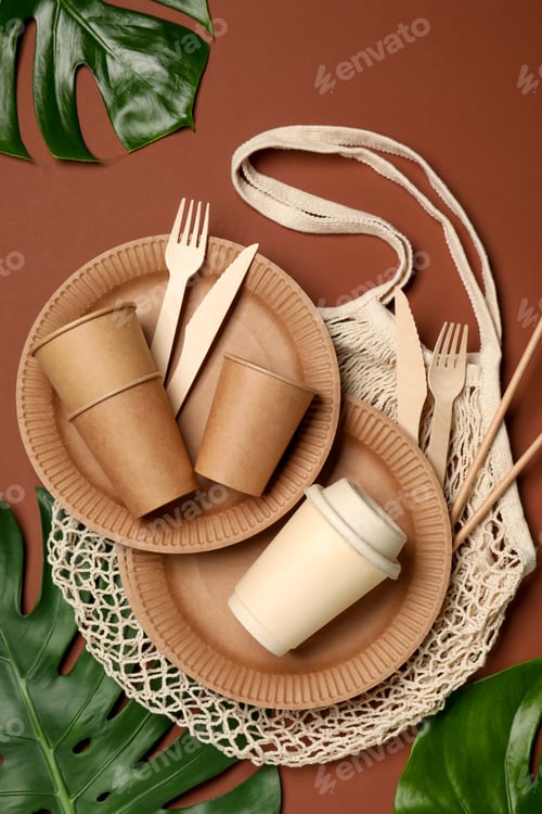 Preview: Flat lay composition with disposable tableware on brown background