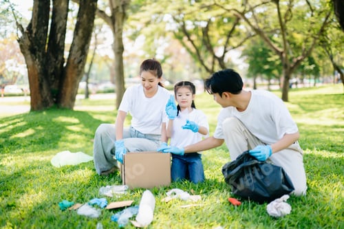 Preview: Joyful family volunteering to clean a park together. A heartwarming outdoor scene promoting