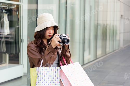 Preview: Asian woman enjoys shopping lifestyle with multiple fashion bags posing with camera for memories