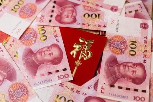 Preview: Closeup shot of 100 Chinese Yuan (CNY) banknotes and Chinese traditional red envelop