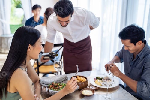 Preview: Caucasian waiter receiving order serving from customer in restaurant.