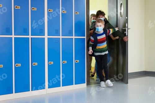 Preview: Group of school children leave the class wearing protective masks