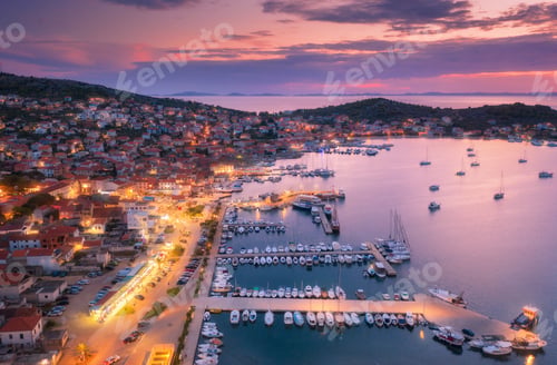 Preview: Aerial view of boats and yachts in port and city at night.