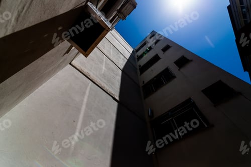 Preview: Low-angle of exterior view of a tall, multi-story building with a blue sky in the background