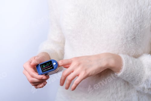 Preview: Person using pulse oximeter device on finger, healthcare monitoring concept