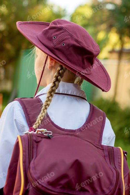 Preview: Back to school. Schoolgirl wearing school uniform and hat