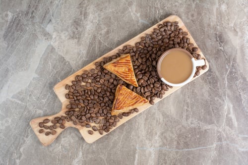 Preview: Cup of coffee, cookies and coffee beans on wooden board