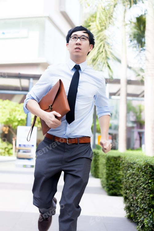 Preview: Young Business Asian exhausted man running late for work