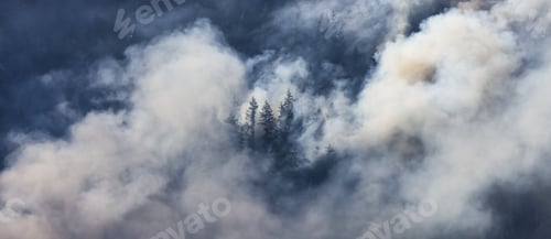 Preview: BC Forest Fire and Smoke over the mountain near Hope during a hot sunny summer day. British Columbia