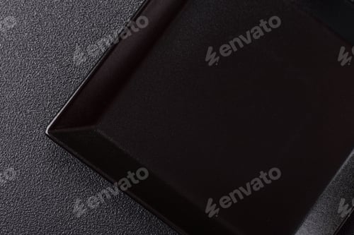 Preview: Empty ceramic round plate on dark textured concrete background