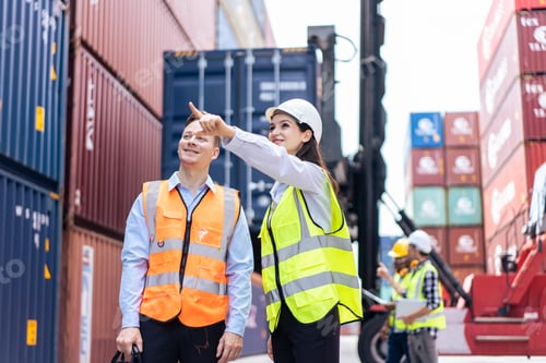 Preview: Caucasian business man and woman worker working in container terminal.