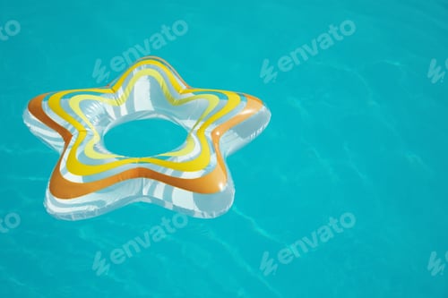 Preview: Star shaped inflatable ring floating in swimming pool on sunny day. Space for text